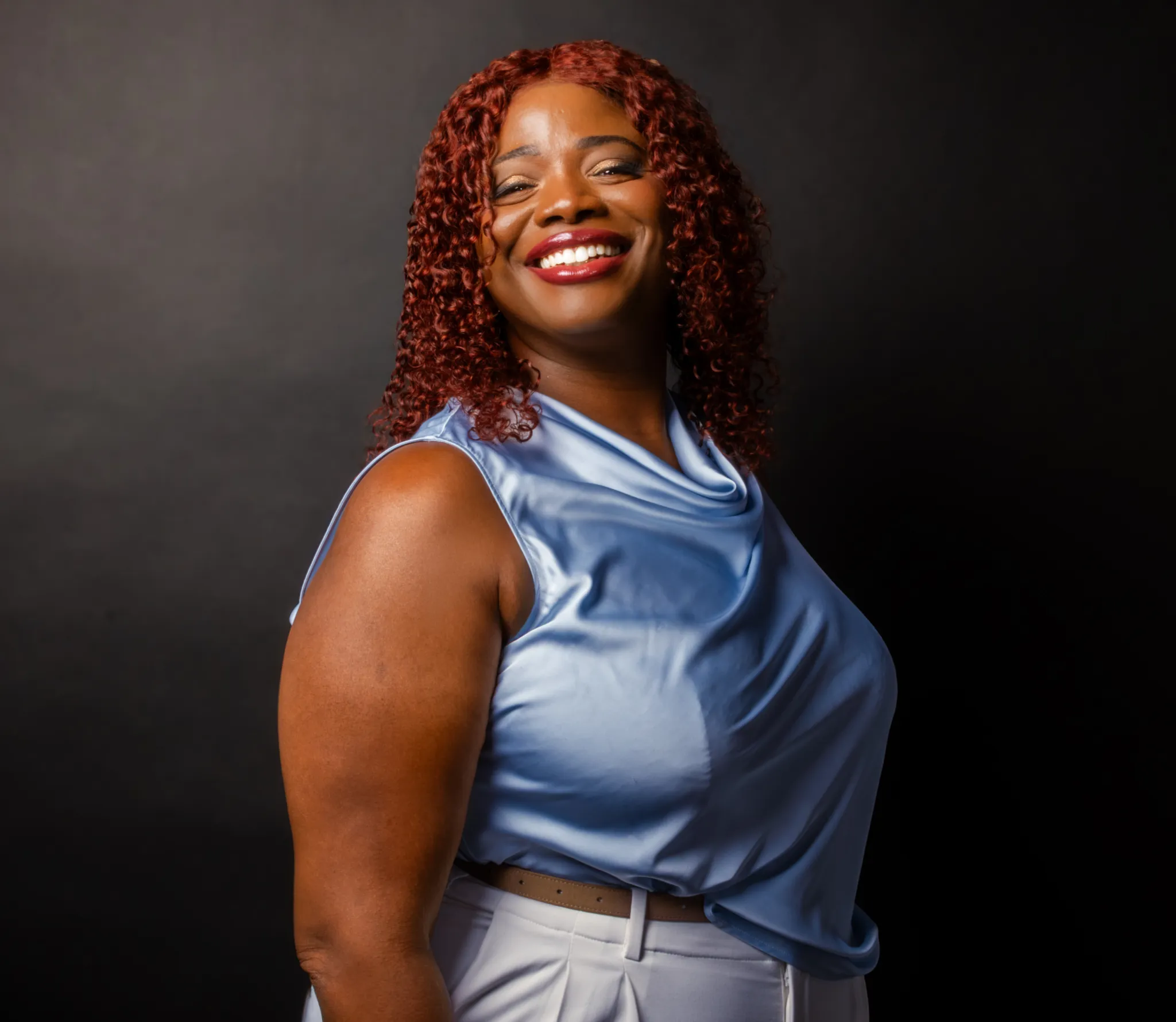 Latoya Reid, founder of ReiSpace, smiling in a three-quarter pose.