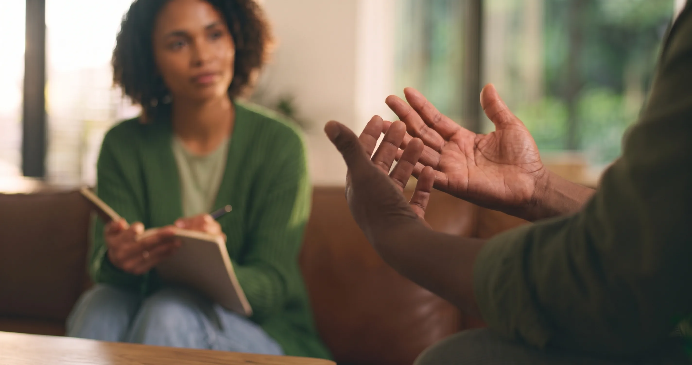 A mental-health practitioner attentively listening during a care conversation.