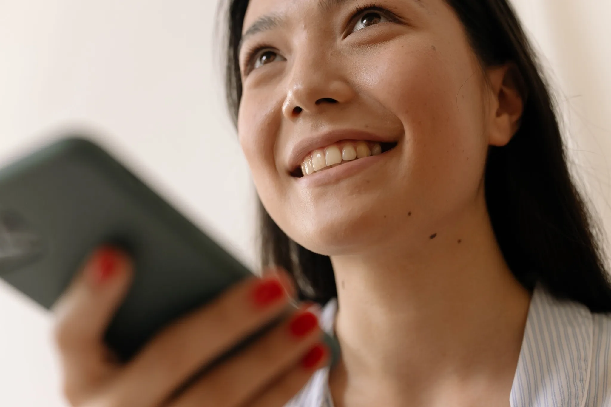 A person taking a quiet moment on their phone at the start of their search for mental-health support.