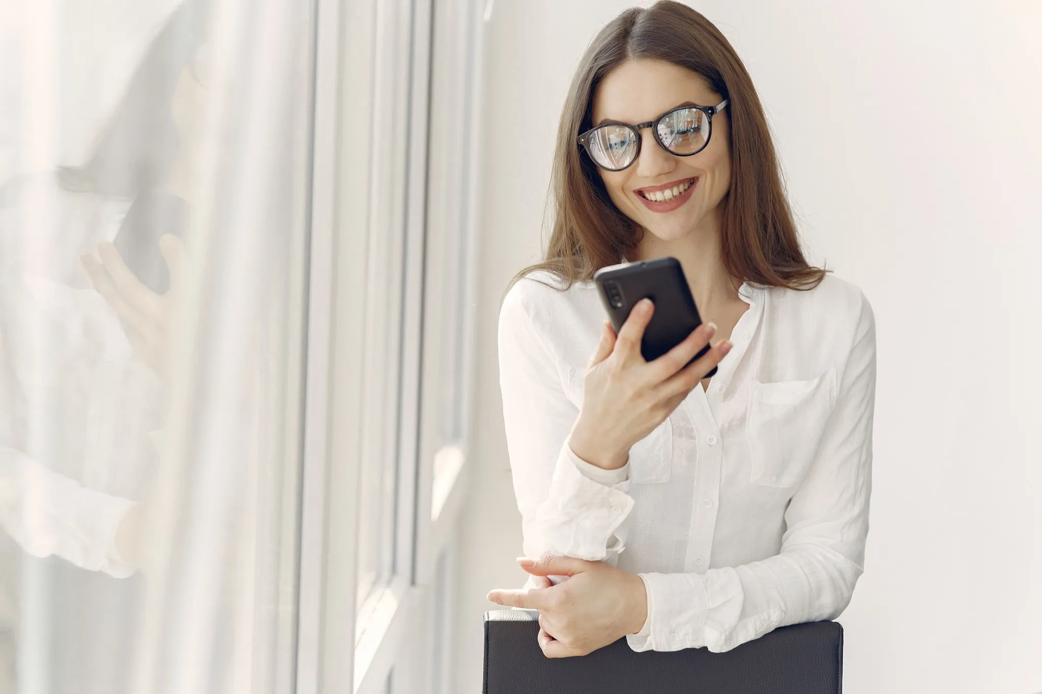 An HR professional reviewing organizational wellness options on a smartphone.